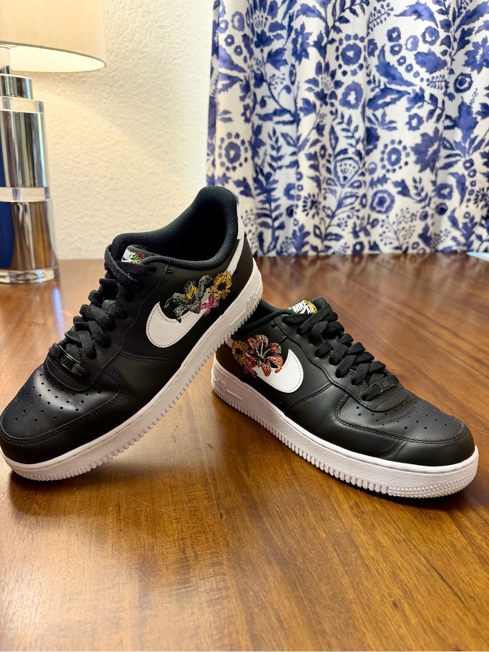 Nike Women's Black Low-Top Sneakers with White Swoosh and Floral Detail